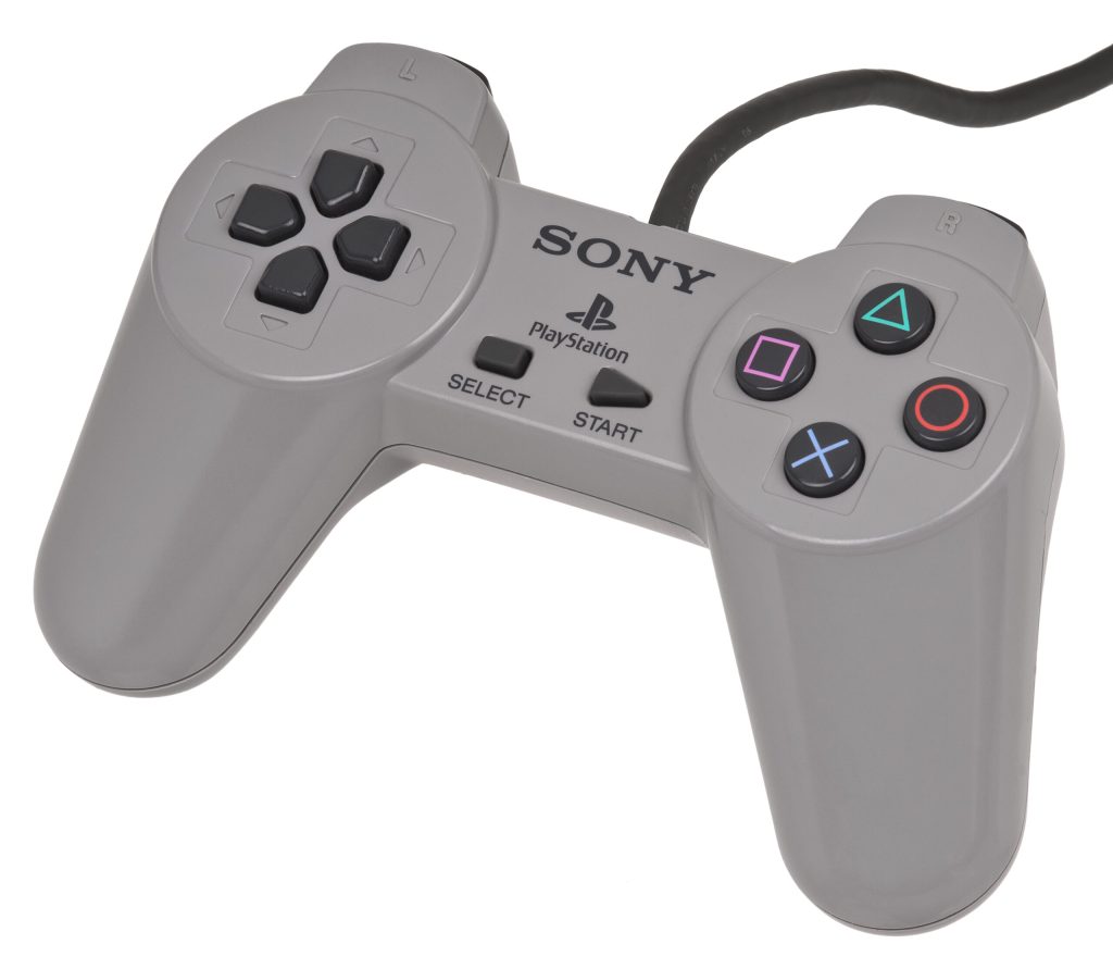 Product picture of an original Sony PlayStation controller on a blank background.