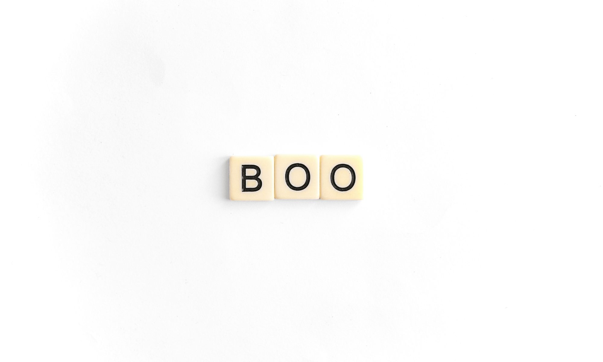 A photo of the word "boo" made using Scrabble tiles on a plain white background.