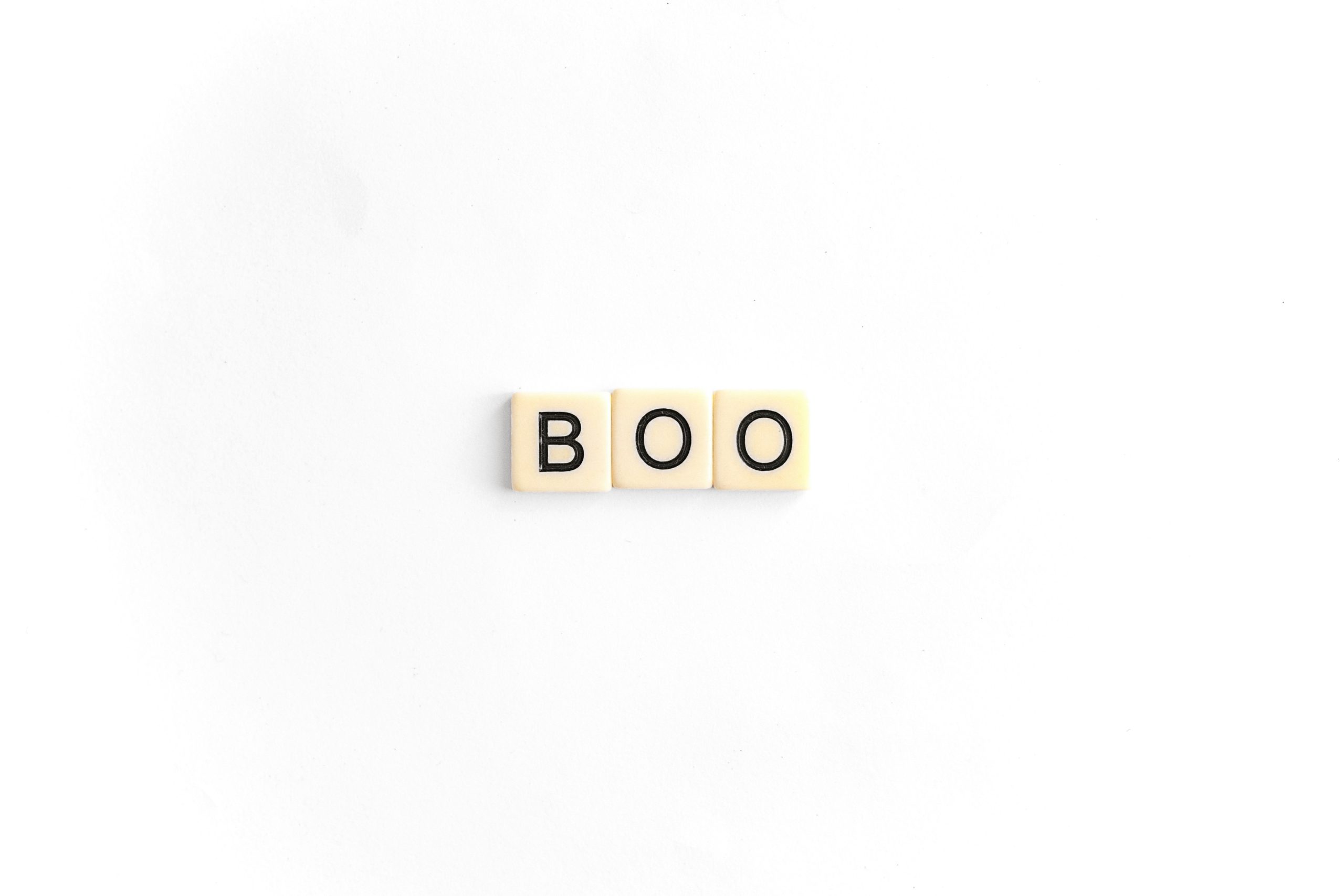 A photo of the word "boo" made using Scrabble tiles on a plain white background.